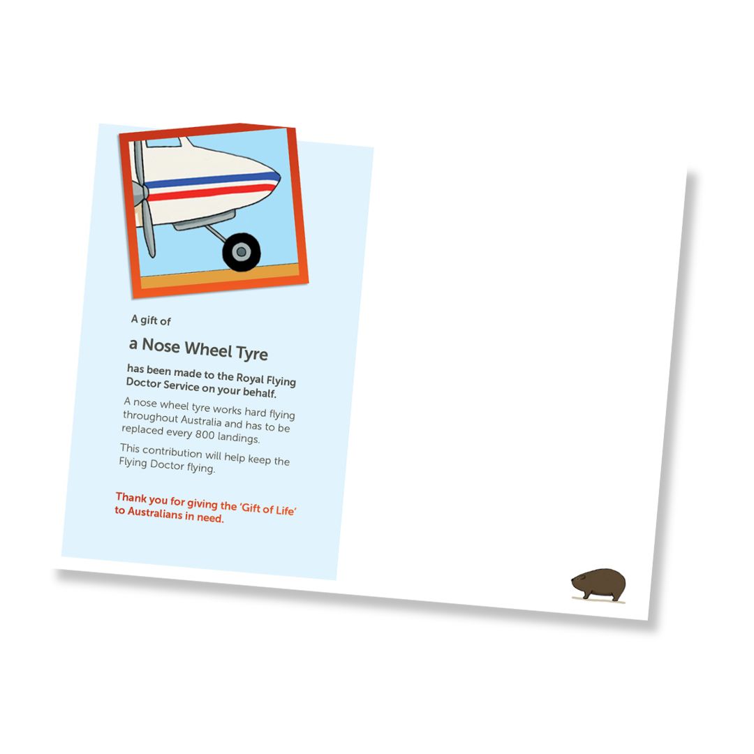 Inside of a card for a nose wheel tyre donation to the Royal Flying Doctor Service, shown at an angle on a white background. The card features a light blue background with text, an illustration of a plane wheel tyre, and a small brown wombat in the bottom right corner.