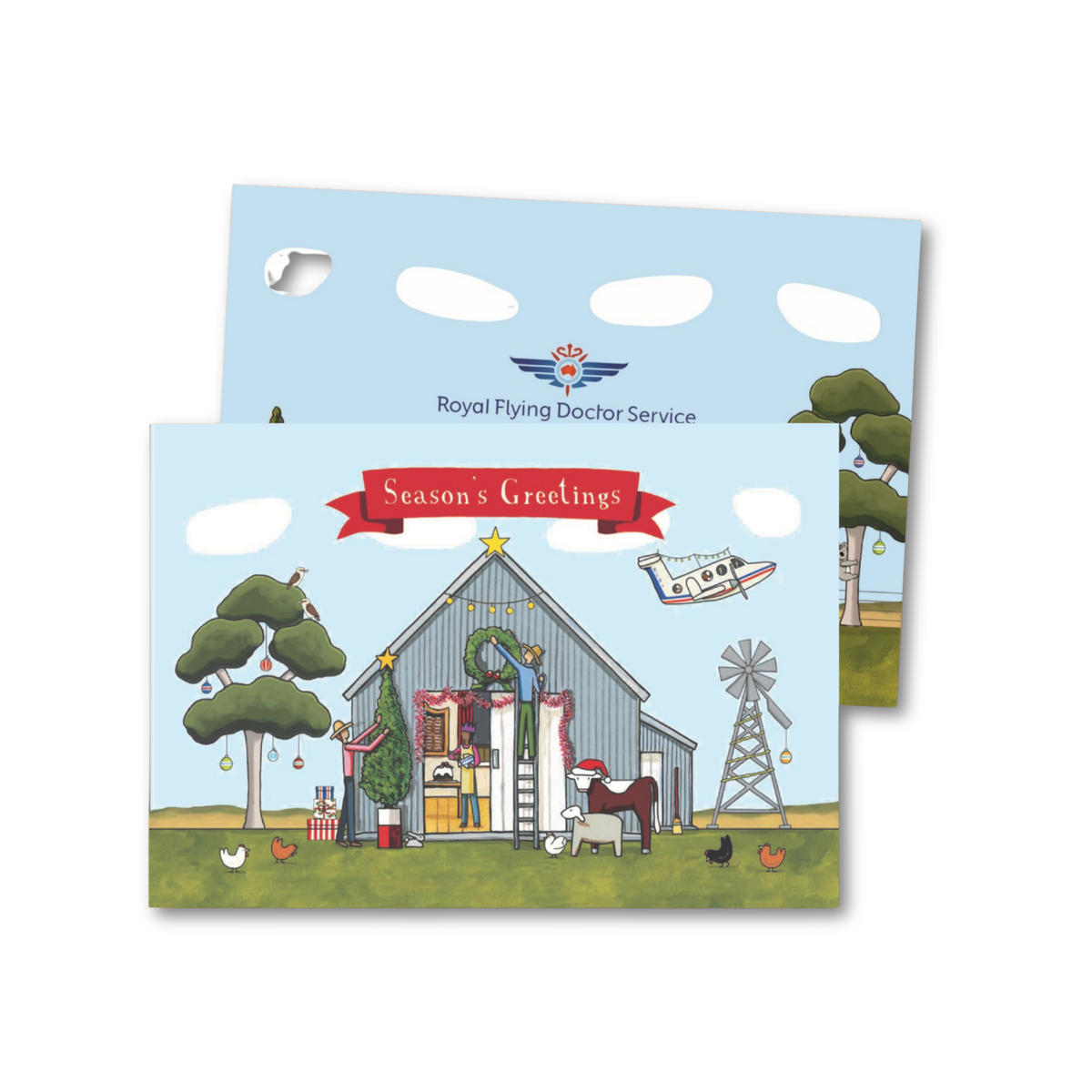 Christmas-themed greeting cards with a barn, trees, and helicopter, featuring 'Royal Flying Doctor Service' branding.