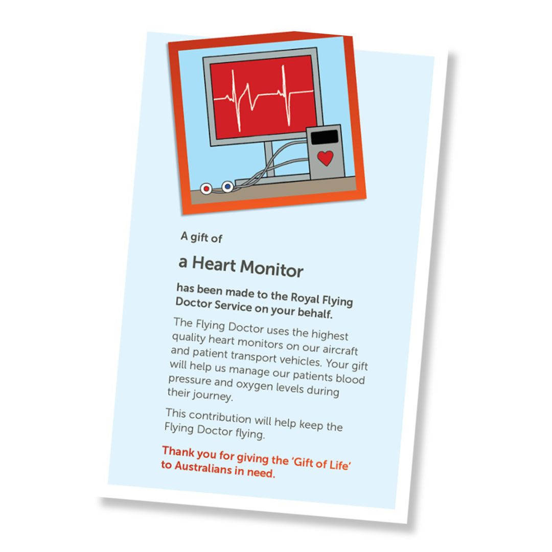 A card for a donation of a heart rate monitor, shown at an angle on a white background. The card has a pale blue field, a small illustrated header with heart rate monitor screen, and a red-orange border, and text stating it is a gift of a heart rate monitor and a that it is a donation to the Royal Flying Doctor Service.