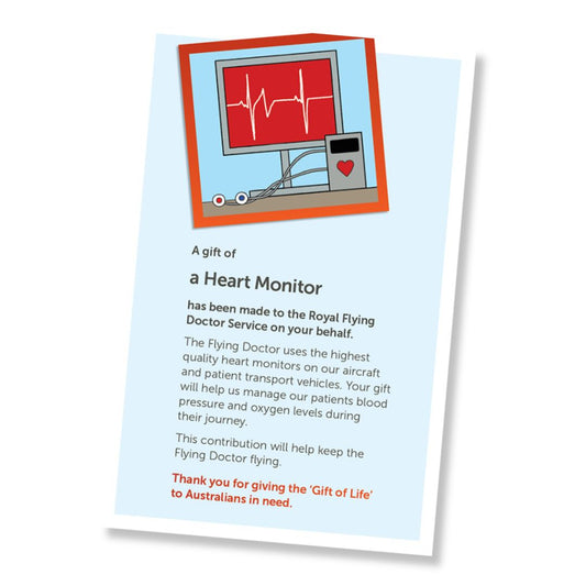 A card for a donation of a heart rate monitor, shown at an angle on a white background. The card has a pale blue field, a small illustrated header with heart rate monitor screen, and a red-orange border, and text stating it is a gift of a heart rate monitor and a that it is a donation to the Royal Flying Doctor Service.