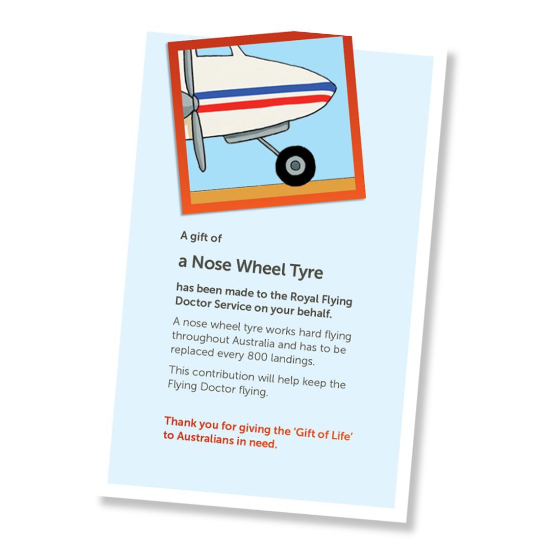 A card for a donation of a nose wheel tyre, shown at an angle on a white background. The card has a pale blue field, a small illustrated header with the front of a plane and it's front wheel tyre, and a red-orange border, and text stating it is a gift of a nose wheel tyre and a that it is a donation to the Royal Flying Doctor Service.