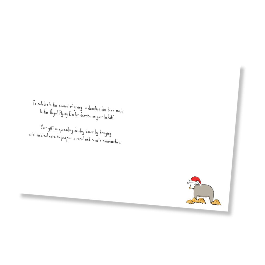 Inside of greeting card shown at an angle on a white background, with printed text that says, "To celebrate the season of giving, a donation has been made to the Royal Flying Doctor Service on your behalf. Your gift is spreading holiday cheer by bringing vital medical care to people in rural and remote communities." on the left side and a small illustration of a gray sheep wearing a red Santa hat eating hay in the lower right corner.